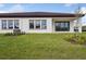Well-maintained backyard with lush green grass and modern exterior design at 1988 Webbstone Way, Zephyrhills, FL 33541