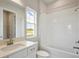 Bright bathroom features white tile backsplash and bath combo at 1988 Webbstone Way, Zephyrhills, FL 33541