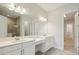 Bright bathroom with double sinks, quartz countertops and a large mirror at 1988 Webbstone Way, Zephyrhills, FL 33541