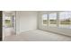 Bedroom bathed in natural light features plush carpeting and multiple windows offering serene views at 1988 Webbstone Way, Zephyrhills, FL 33541