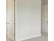 Bedroom features neutral carpet and trim, and multiple entry doors at 1988 Webbstone Way, Zephyrhills, FL 33541