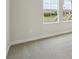 Bedroom with neutral carpet, trim, and a double window at 1988 Webbstone Way, Zephyrhills, FL 33541
