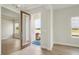 Home's entryway boasts a large front door and a view into the adjacent front living area at 1988 Webbstone Way, Zephyrhills, FL 33541