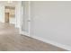 Bright hallway with light wood floors leading to kitchen at 1988 Webbstone Way, Zephyrhills, FL 33541