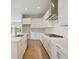 Modern kitchen with white cabinets, stainless steel appliances, and a large island with white countertops at 1988 Webbstone Way, Zephyrhills, FL 33541