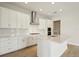 Bright kitchen featuring white cabinetry, stainless steel appliances, and an island with white countertops at 1988 Webbstone Way, Zephyrhills, FL 33541