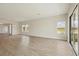 Open-concept living room boasts natural light, laminate floors and seamless flow for modern living at 1988 Webbstone Way, Zephyrhills, FL 33541