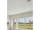 An interior view that features sliding glass doors leading to an outdoor area with a calming view at 1988 Webbstone Way, Zephyrhills, FL 33541
