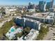 Aerial image of a building with a swimming pool, green landscaping, and the city skyline in the background at 201 W Laurel St # 811, Tampa, FL 33602