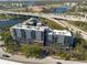 Aerial view showcases a multi-story condo with balconies, water views, and highway access at 201 W Laurel St # 811, Tampa, FL 33602