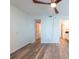 Bedroom featuring wood-look floors, ceiling fan, and multiple access doors at 201 W Laurel St # 811, Tampa, FL 33602