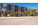 Multi-story condo with balconies, lush landscaping, and street view on a clear, sunny day at 201 W Laurel St # 811, Tampa, FL 33602