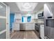 Bright kitchen with white cabinets, stainless steel appliances, and a light-filled breakfast bar overlooking the dining area at 201 W Laurel St # 811, Tampa, FL 33602