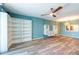 Living room featuring wood-look floors, built-in shelves, and view into kitchen at 201 W Laurel St # 811, Tampa, FL 33602