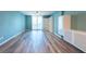 Living room showcasing wood floors, a ceiling fan, and sliding glass door to a balcony at 201 W Laurel St # 811, Tampa, FL 33602