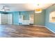 Living room featuring wood floors, white built-ins, and a modern light fixture at 201 W Laurel St # 811, Tampa, FL 33602