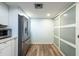 Kitchen area features stainless steel refrigerator and pantry with sliding doors at 201 W Laurel St # 811, Tampa, FL 33602