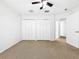 Bedroom has carpet, ceiling fan, closet, and neutral walls, providing ample storage and a comfortable space at 20151 Bay Cedar Ave, Tampa, FL 33647