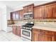 Well-equipped kitchen with stainless steel appliances and ample dark wood cabinet space at 20151 Bay Cedar Ave, Tampa, FL 33647