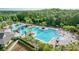 An elevated view of the community pool and surrounding amenities: bridges, waterslide, and tables at 20151 Bay Cedar Ave, Tampa, FL 33647