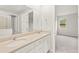 Bathroom featuring double sinks, modern fixtures, and a view of the yard at 20387 Symphony Pl, Venice, FL 34293