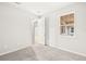 This bedroom has neutral carpet and bright windows at 20387 Symphony Pl, Venice, FL 34293