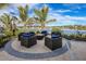 Outdoor seating area with a fire pit and lake view at 20387 Symphony Pl, Venice, FL 34293