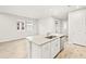 Bright kitchen with stainless steel appliances, quartz counters and island sink at 20387 Symphony Pl, Venice, FL 34293