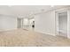 Spacious living room with neutral walls, tile flooring, and open kitchen access at 20387 Symphony Pl, Venice, FL 34293