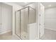 Modern shower features tile and glass doors at 20387 Symphony Pl, Venice, FL 34293