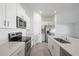 A kitchen featuring stainless steel appliances, modern cabinetry, and an island with a sink at 20400 Laverne Ave, Port Charlotte, FL 33981