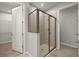 Modern bathroom featuring a glass-enclosed shower and access to a walk-in closet at 20405 Symphony Pl, Venice, FL 34293