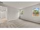 Comfortable carpeted bedroom with two windows providing ample natural light at 20405 Symphony Pl, Venice, FL 34293