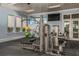 Fitness center featuring modern machines, ample space, and natural light from large windows at 20405 Symphony Pl, Venice, FL 34293