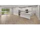 Open-concept kitchen featuring stainless steel appliances, center island, tile flooring, and sliding glass doors at 20405 Symphony Pl, Venice, FL 34293