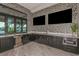 Modern kitchenette with black cabinets, stainless steel appliances, and view of the pool area at 20405 Symphony Pl, Venice, FL 34293