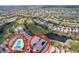 Aerial view showcases the home's location within a community with a pool, golf course, and water features at 23717 Coral Ridge Ln, Land O Lakes, FL 34639