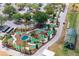 Aerial view of a miniature golf course featuring winding paths, water features, and lush landscaping at 23717 Coral Ridge Ln, Land O Lakes, FL 34639