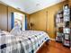 Comfortable bedroom with a four-poster bed, wood floors, and a cozy ambiance at 23717 Coral Ridge Ln, Land O Lakes, FL 34639