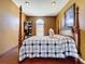 Bedroom featuring a four-poster bed, window, and neutral color palette at 23717 Coral Ridge Ln, Land O Lakes, FL 34639