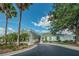 Exterior of clubhouse surrounded by palm trees, landscape and circle drive at 23717 Coral Ridge Ln, Land O Lakes, FL 34639
