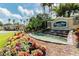 Beautiful community entrance featuring a waterfall and lush landscaping at 23717 Coral Ridge Ln, Land O Lakes, FL 34639
