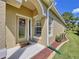 Welcoming front entry with decorative door and sidelight, complemented by neat landscaping at 23717 Coral Ridge Ln, Land O Lakes, FL 34639