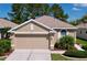 Charming single-Gathering home featuring a two-car garage, manicured lawn and tasteful landscaping at 23717 Coral Ridge Ln, Land O Lakes, FL 34639