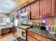 Kitchen with stainless steel appliances, granite countertops, and stylish wooden cabinets at 23717 Coral Ridge Ln, Land O Lakes, FL 34639