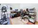 Well-lit home office featuring multiple work spaces and exercise equipment at 23717 Coral Ridge Ln, Land O Lakes, FL 34639
