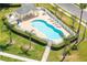 Community pool featuring ample seating, lush landscaping, and a cabana for residents' enjoyment and relaxation at 23717 Coral Ridge Ln, Land O Lakes, FL 34639