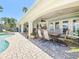 Relaxing backyard patio and pool features brick pavers, outdoor seating, and lush landscaping at 2593 W Vina Del Mar Blvd, St Pete Beach, FL 33706