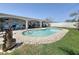 Backyard featuring a freeform swimming pool and covered patio with outdoor seating at 2593 W Vina Del Mar Blvd, St Pete Beach, FL 33706