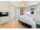 Bright bedroom with white bedding, wicker furniture, and French doors to the outside at 2593 W Vina Del Mar Blvd, St Pete Beach, FL 33706